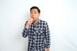 © M Alfan Setyawan - unhealthy asian man coughing feeling unwell isolated on white background wearing casual shirt
