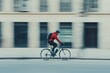 © KerXing - A man in a red jacket rides a bicycle down a street