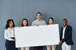 © peopleimages.com - Group, business people and portrait with banner for advertising, marketing and corporate announcement. Gray background, men and women with mockup space for poster, billboard and about us with message