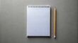 © Far - Blank notebook mockup with pencil on grey background high angle