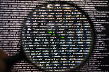 css code in magnifying glass abstract technology background