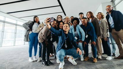 Wall Mural - diverse business team taking group selfie at a work conference