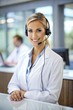 © Tekin - Confident Receptionist Using Headset In Hospital