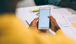 © BullRun - Faceless partner surfing smartphone during meeting