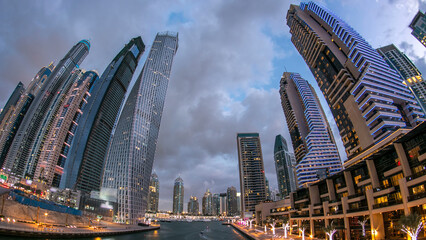 Wall Mural - Dubai Marina towers and canal in Dubai day to night timelapse