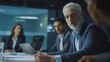 © Julia - Male mature caucasian ceo businessman leader with diverse coworkers team, executive managers group at meeting. Multicultural professional businesspeople working together on research plan in boardroom.