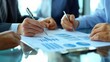 © WS Studio 1985 - Collaborative Efforts of Professionals Engaging in Strategic Planning and Analysis with Charts and Graphs during a Business Meeting in a Modern Office Environment