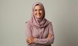 © Vitalii - Old woman in hijab smiles on simple background