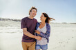 © Marko Geber - Happy couple walking on the beach together on a sunny day