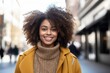 © Baba Images - Portrait of a smiling young African American woman in the city