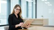 © velikiyzayats - Professional Woman Using Tablet in Modern Office Setting, Ideal for Business Marketing, Technology, and Professional Development Concepts