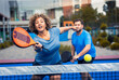 © Zoran Zeremski - Mixed adult couple palying padel on outdoor court.