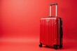 ©  S u n n y B u n n y - Modern red suitcase on vibrant background for contemporary travel themes.