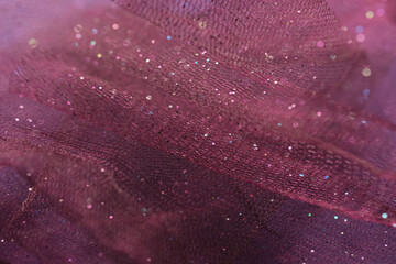 Purple tulle fabric with sparkling glitter. Christmas concept background. Close up macro