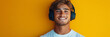 © Henryzoom - The image showcases a happy European male with headphones, radiating positivity and enjoyment of life, all framed by a soothing pink backdrop for a stylish mock-up design, banner