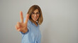 © Krakenimages.com - Woman smiling showing peace gesture with fingers against isolated white background