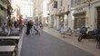 © Krakenimages.com - Blurred street in marseilles with people, cafes, cobblestone, tables, and european architecture conveying a busy outdoor atmosphere in france.