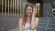 © Krakenimages.com - Young attractive blonde woman smiling outdoors in an urban street setting, showcasing her beauty and charm as she poses confidently on a city road