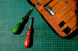© ADDICTIVE STOCK - Leather craft tools on cutting mat for detail work