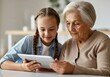 © Running opossum - Granddaughter showing interesting content on a digital tablet to her grandmother, spending quality time together