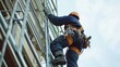 © Vitalii But - high rise fitter ascends scaffolding equipped various tools demonstrating remarkable skill and focus while working significant altitude city.