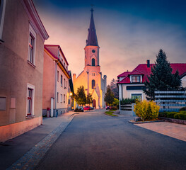 Canvas Print - Earli morning autumn view of illuminated Catholic Church of Ebenfurth (St. Ulrich). Nice cityscape of Ebenfurth city municipality in district of Wiener Neustadt-Land, Lower Austria.