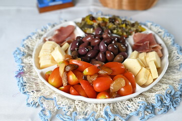 portion of olives with cheese cherry tomatoes and parma ham snack healthy food vegan salad