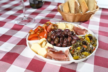 portion of olives with cheese cherry tomatoes and parma ham snack healthy food vegan salad