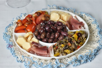 portion of olives with cheese cherry tomatoes and parma ham snack healthy food vegan salad