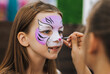 © shchus - Professional make-up artist, artist paints face painting with watercolors, make-up for a happy girl, a smiling child at a party. Photography, portrait.