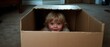 © Ai Studio - A gleeful child playfully hides inside a cardboard box in a warm, carpeted room, sharing a moment of spontaneous and carefree fun.