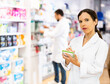 © JackF - Portrait of female druggist making notes while working in drugstore.