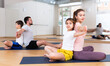 © JackF - Young woman practicing yoga in pair with her teen daughter during family workout at gym