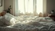 © Galib - A cozy bedroom with a white bed and white curtains, bathed in sunlight streaming through the window.
