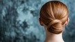 © Sampao - Elegant Back View of a Woman with Smooth Red Hair in a Neat Bun Against a Textured Blue Background Highlighting Hair Styling and Simple Beauty