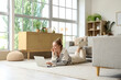 © Pixel-Shot - Young woman using modern laptop on floor at home