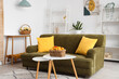 © Pixel-Shot - Comfortable sofa and basket of apricots on coffee table in living room
