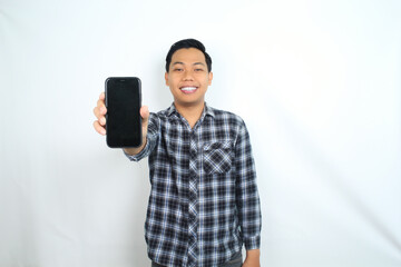 attractive asian man showing smartphone empty screen with smiling face wear casual shirt isolated on white