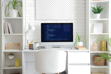 Wall Mural - computer monitor with programming code on desk in office