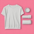 © vixer.std - A layout of a plain white t-shirt and rolled-up fabric on a pink background.