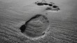 © Bimha - A single footprint in the sand with a starfish imprint, representing a moment of presence and the journey of life.