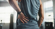 © Coetzee/peopleimages.com - Man, hands and back pain with injury at gym for muscle tension, workout accident or sprain. Closeup, male person or athlete with sore spine, pinch nerve or ache for joint inflammation at health club