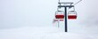 © Aventurine - Winter storm blizzard intensity, A snowy landscape featuring a ski lift with red chairs, shrouded in fog and heavy snowfall, creating a serene yet isolating winter scene.