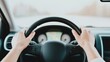 © nattapon98 - A person grips the steering wheel of a car, focusing on the road ahead, creating a sense of motion and adventure.