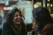 © Ibnu - Woman Laughing with a Friend in a Cafe