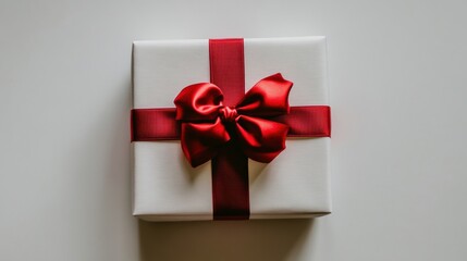 Wall Mural - Decorative red ribbon with bow on a white gift box