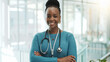 © peopleimages.com - Black woman, doctor and smile with arms crossed at clinic on portrait with pride for healthcare in Uganda. Female person, employee and medical professional with confidence or happy for medicine