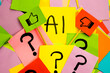 © Answer 7 - Yellow sticky note with black lettering saying AI with like and dislike flag on colored papers with question marks, concept of acceptance and dislike about the AI and the future