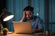 © SimpleDesignStudio - Stressed Man Working Late at Night on Laptop in Blue-Lit Office, Perfect for Stress Awareness Campaigns or Work-from-Home Themes