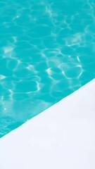 Poster - The vibrant turquoise water of a swimming pool meets a clean white surface, forming a diagonal line that evokes a sense of coolness and summer relaxation